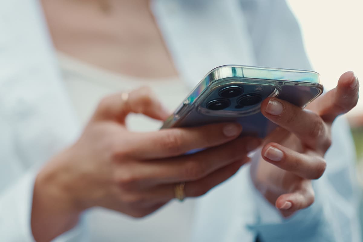 Close-up of a woman using a smartphone to search for information online.