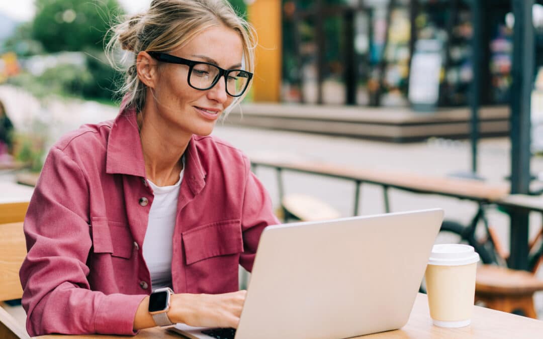 How Google AI Overviews Are Changing SEO : Business owner working on a laptop while learning about Google AI Overviews and SEO
