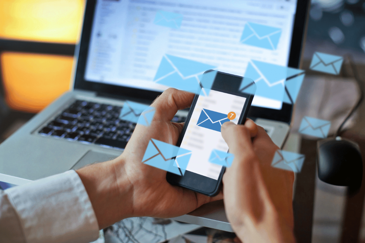 Woman using a smartphone for email marketing after knowing what to do after you create a lead magnet