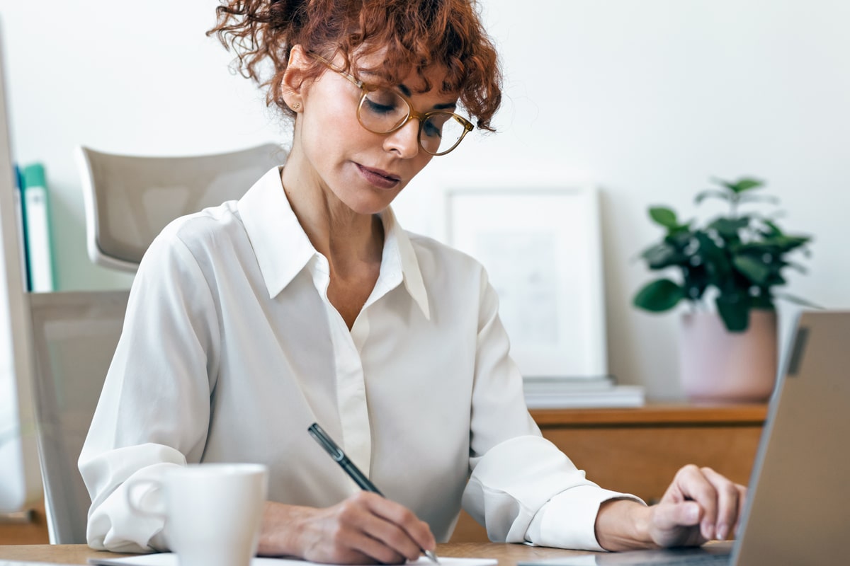 Business owner making a list of services to organize her website service pages.