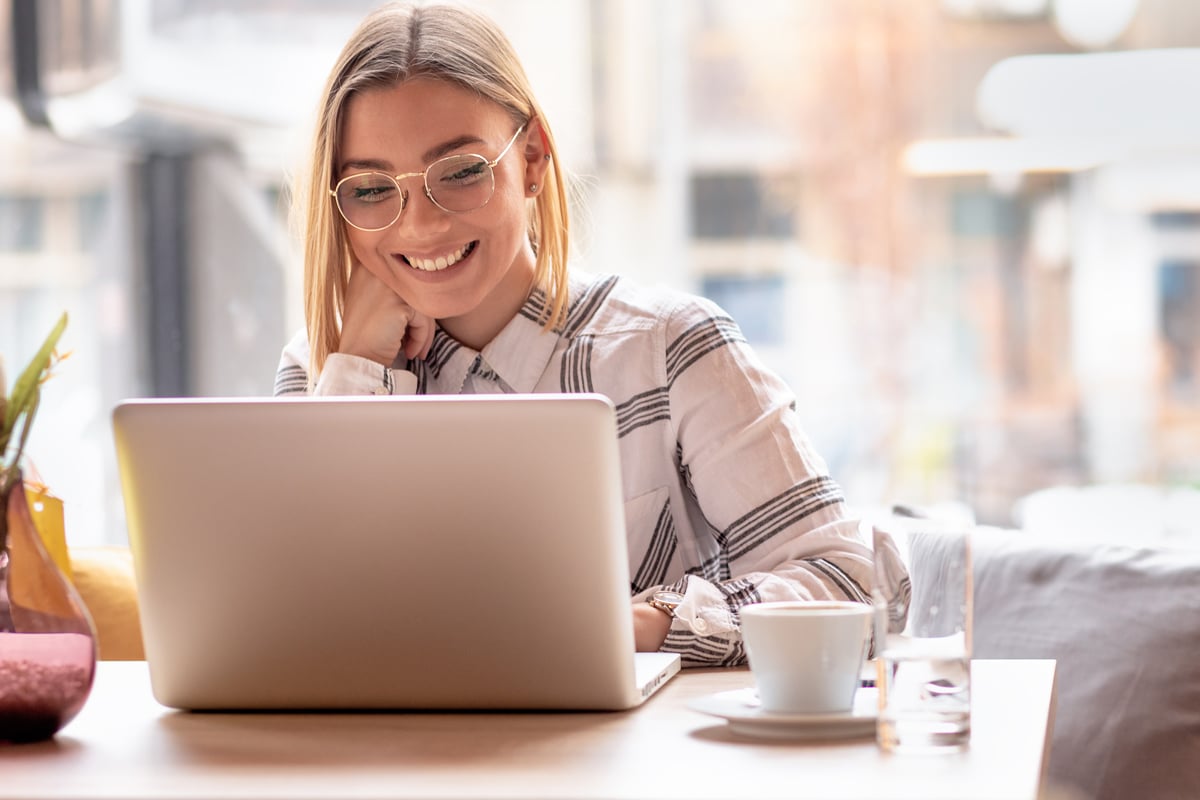 Business owner researching keywords for website service pages on her laptop.