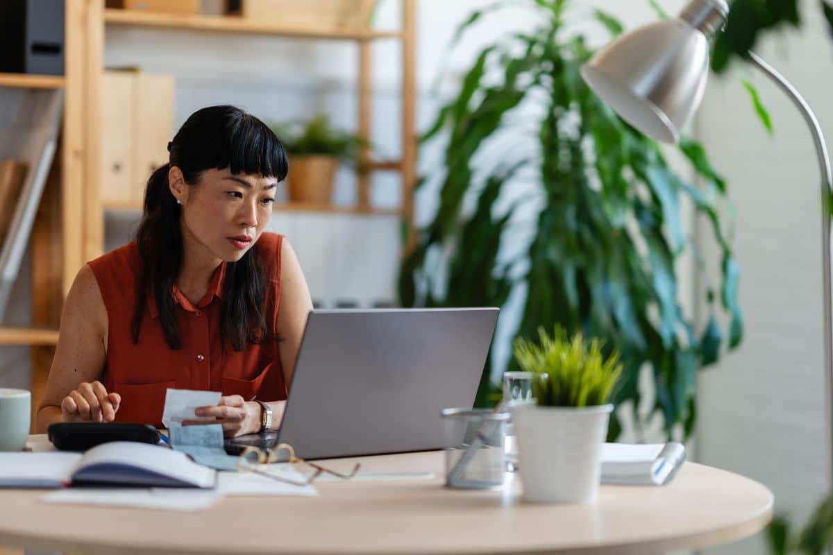 Small business owner reviewing AI automation platform costs and software subscriptions before purchasing.